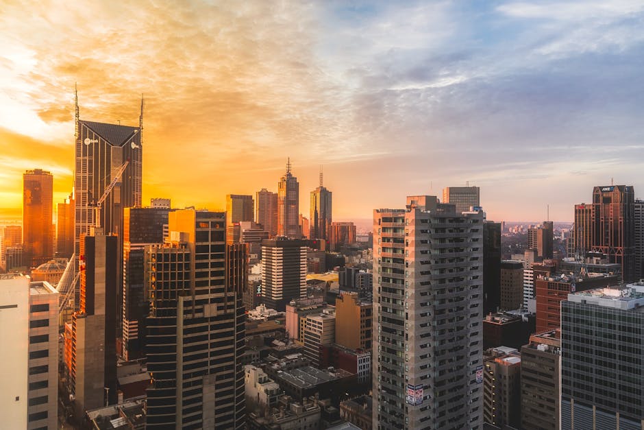 Stunning view of Melbourne's skyline at sunset, capturing modern skyscrapers and warm sky