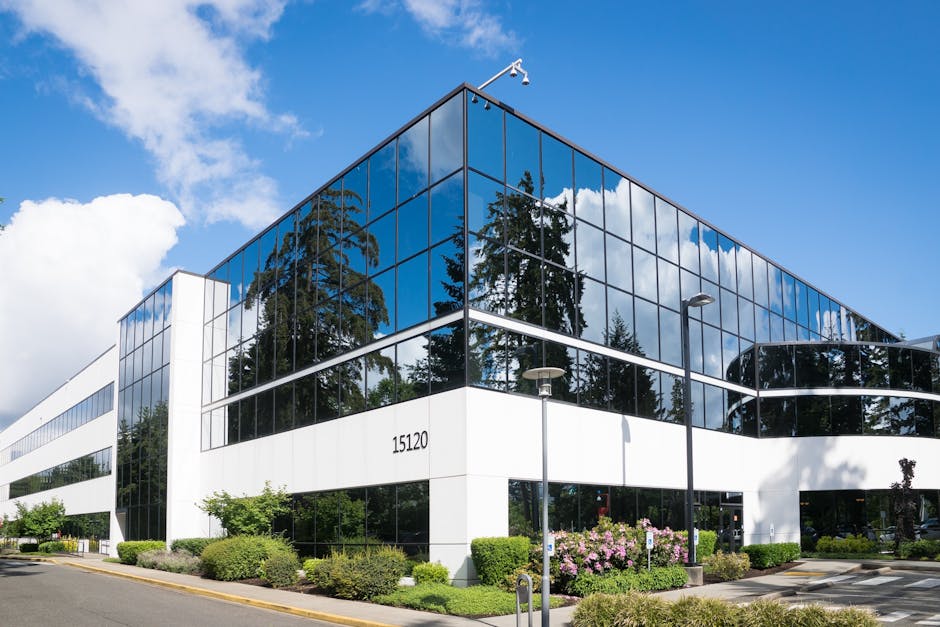 Contemporary office building in Redmond with reflective glass and lush greenery
